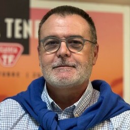 foto de víctor machado ponte. Lleva gafas, camisa blaca a cuadros azules y sweater azul en los hombros